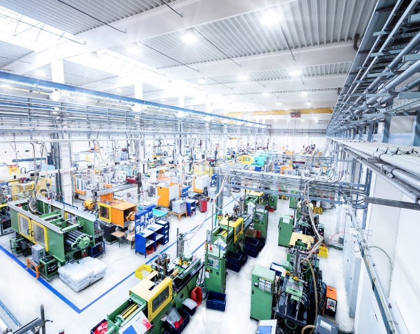Lighting specialists install LED lighting in warehouse.